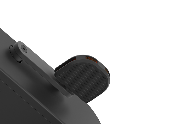 Close-up of a black, modern security camera mounted on a dark surface with an adjustable arm.